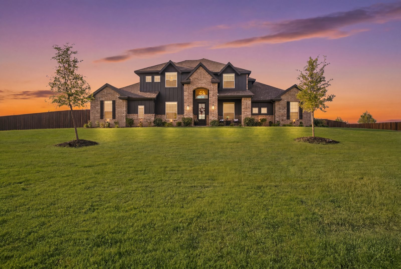 Home exterior at twilight with warm glowing windows, Ellis County