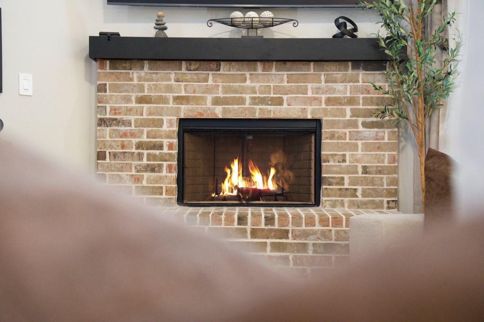Fireplace detail with a lit fire, Ellis County