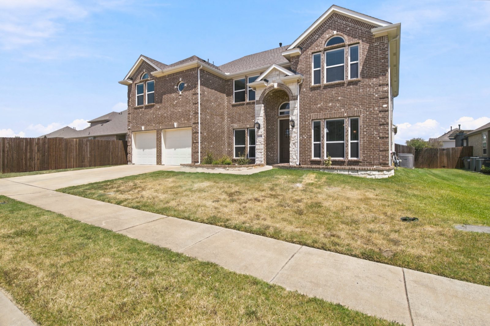 Front elevation of a two story home under blue sky, Ellis County