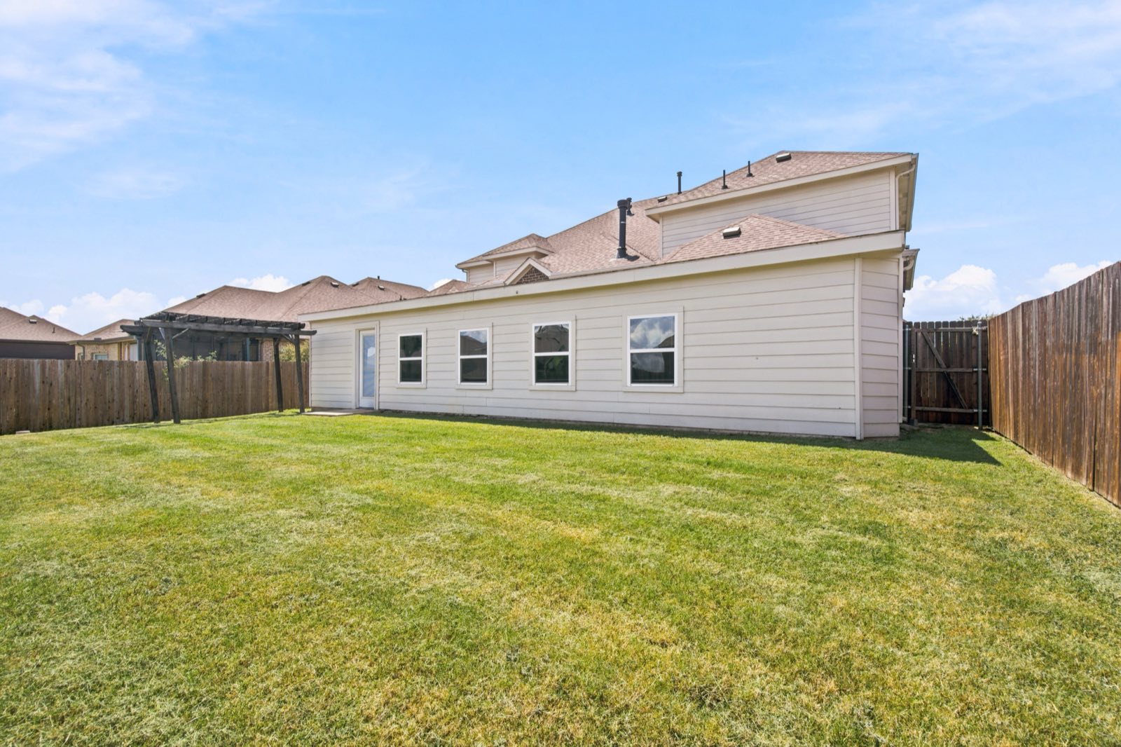 Backyard lawn with the rear elevation centered, Ellis County