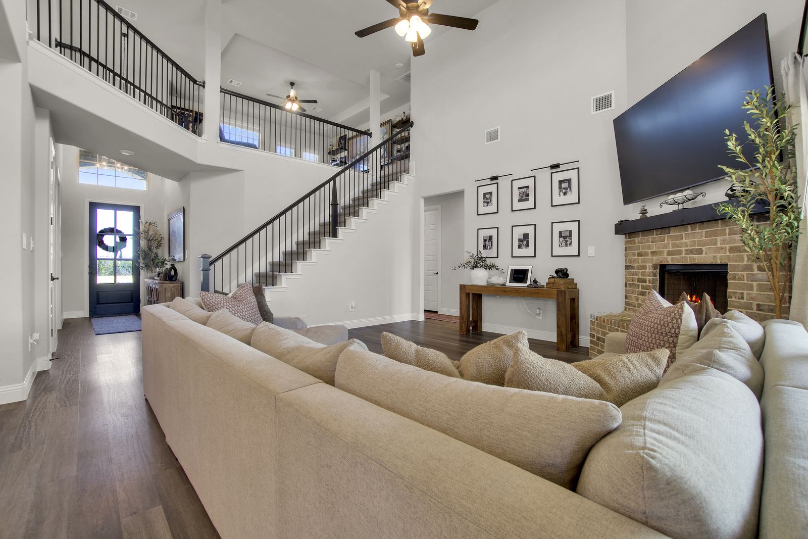 Two-story living room with staircase and natural light