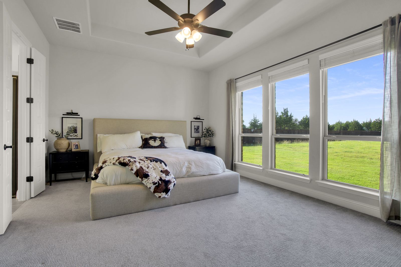 Primary bedroom suite, styled and naturally lit